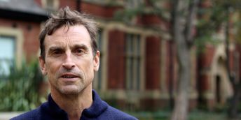 A profile image of Kenton Cool standing outside the Baines at the University of Leeds