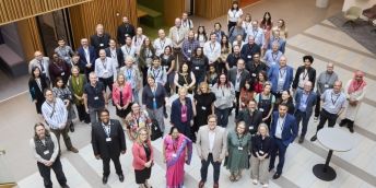 A large group of people stood in the Nexus foyer.