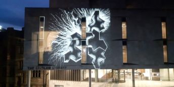 A graphic white light display projected onto the Laidlaw Library.