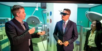 Wes Streeting, Secretary of State with a virtual reality headset on talking to Peter Woodthorpe and Dr Yee Mun Lee.