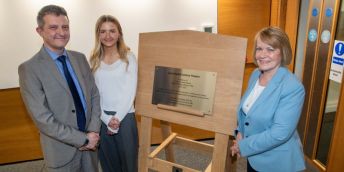 Mark McKelvie, Anne's husband with their daughter Rachel and Professor Dame Jane Francis, Chancellor of the University of Leeds. They are stood around the plaque that names the new lecture theatre.