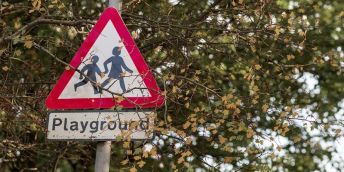 Street sign which says 'Playground'
