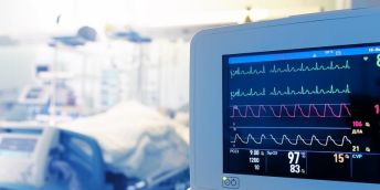 A heart monitoring device at the end of a hospital bed