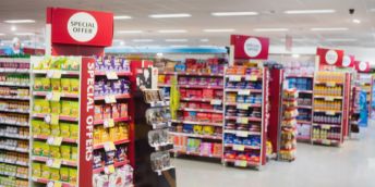 Interior of a supermarket showing end of aisle displays containing products high in sugar