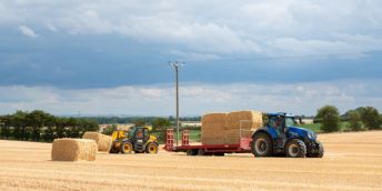 A tractor involved in hay-making in the sunshine on the University of Leeds farm