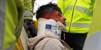 Emergency services take care of a victim of a car that crashed as a result of drug-driving bu putting on a neck brace.