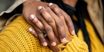 A hand around a person's shoulder