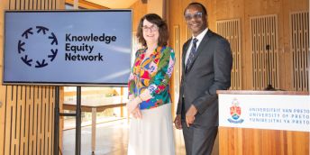 Professor Simone Buitendijk, Vice-Chancellor and President of the University of Leeds, and Professor Tawana Kupe, Vice Chancellor and Principal of the University of Pretoria on a podium next to Knowledge Equity Network signage.