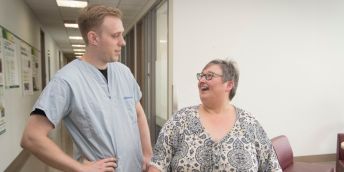 A patient with obesity talking to a doctor in hospital