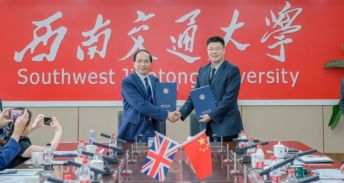 Professor Hai Sui Yu with SWJTU President Xuedong Yan shaking hands and holding a strategic agreement.