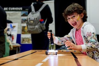 Child playing with a robotic toy.