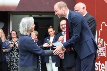 Suzanne Glavin shaking hands with HRH Prince of Wales and recieving her brooch.
