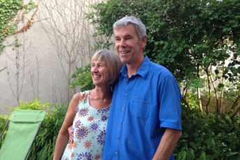 Sue and Peter Cullimore stand together in their garden