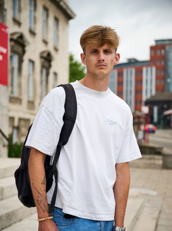 Romy Harwood Walton, a student, stood in front of a University building.
