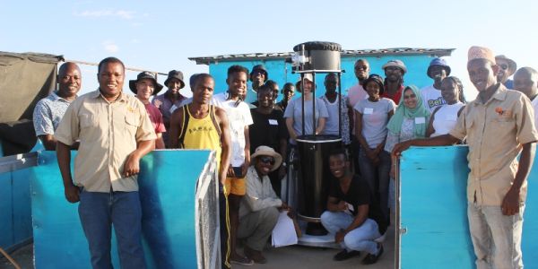 Group of students, tutors and staff with a 40cm optical telescope in Kenya