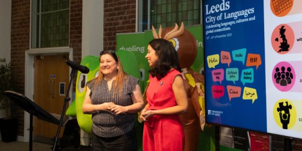 Bettina Hermoso-Gómez and Sofia Martinho at the closing ceremony, with Duo the owl and Leeds city mascots in the background.