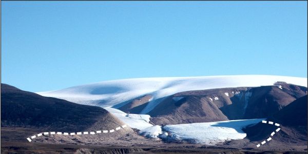 Scarlet heart glacier in Greenland, with bare mountain surrounding the glacier and blue sky in background. White dotted lines surround a bare area circling the glacier.