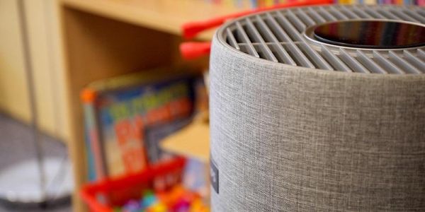 An air filtration system, with books and toys in the background