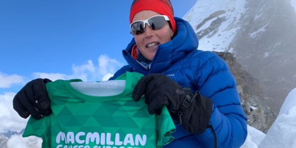 Shaunna Burke holds a Macmillan Cancer Support shirt at the summit of Lobuche East