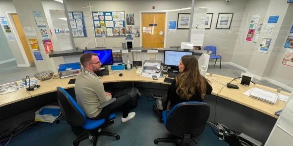 The Business Manager and the Patient Navigator at The Light Surgery in Leeds sit on reception and chat to each other.