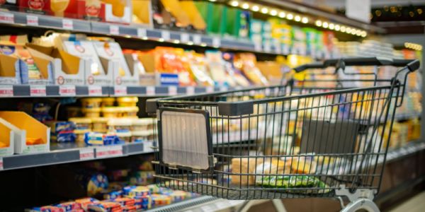 A supermarket trolley in a supermarket aisle