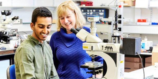 Professor Helen Gleeson and Devesh Mistry working together in a laboratory