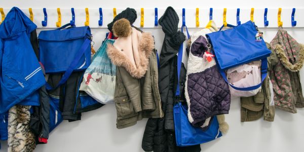 Rack of book bags and coats on pegs