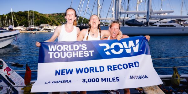 Team of three celebrate behind world record banner