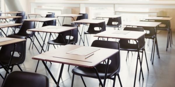 Rows of empty school desks and chairs