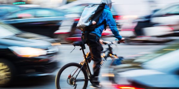 a cyclist in busy traffic