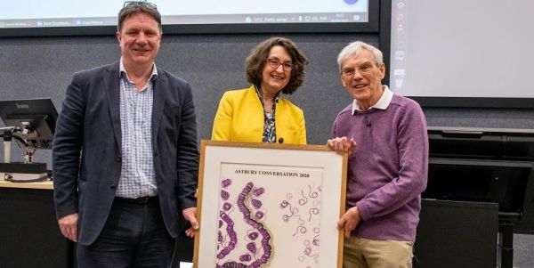 Professor Neil Ranson, Professor Simone Buitendijk and Dr Richard Henderson posing with a frame with the text 'Astbury Conversation 2020'.