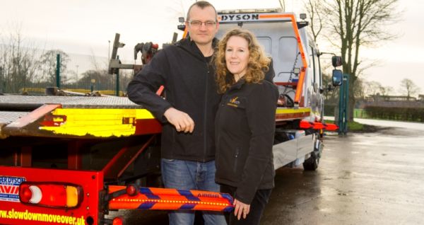 Simon and Sarah Scaife stand behind an AirBar fitted to a transporter vehicle.