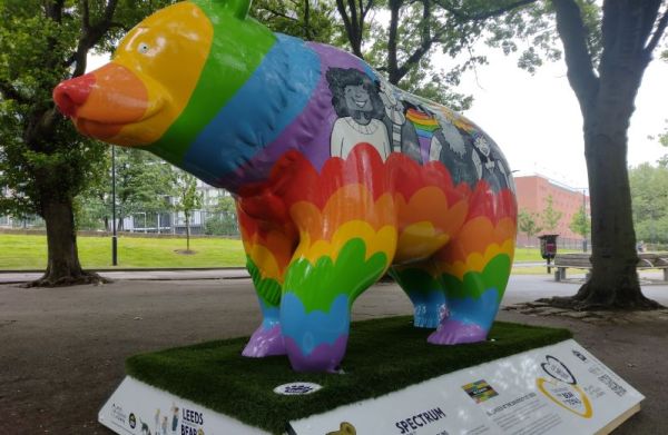 Spectrum, a colourful bear sculpture, on a grassed area at the University.
