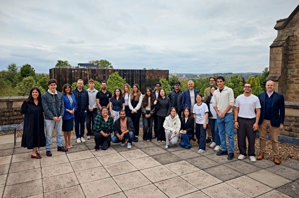 Students and experts gathered on a rooftop