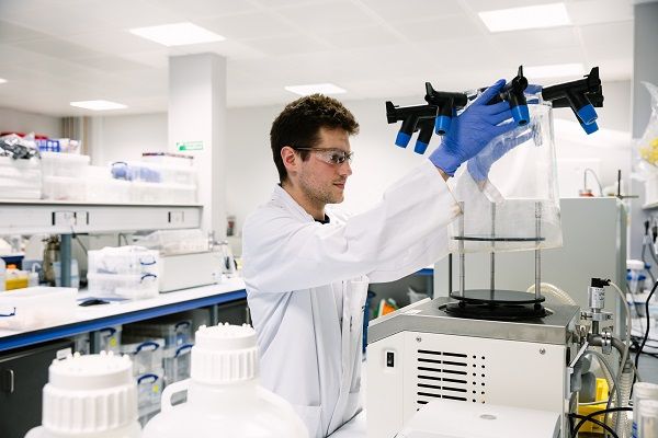 A researcher adjusts equipment in a research lab