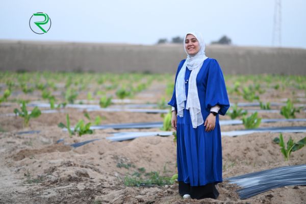 Aya Al Sharqawy stands in a field of crops in Egypt