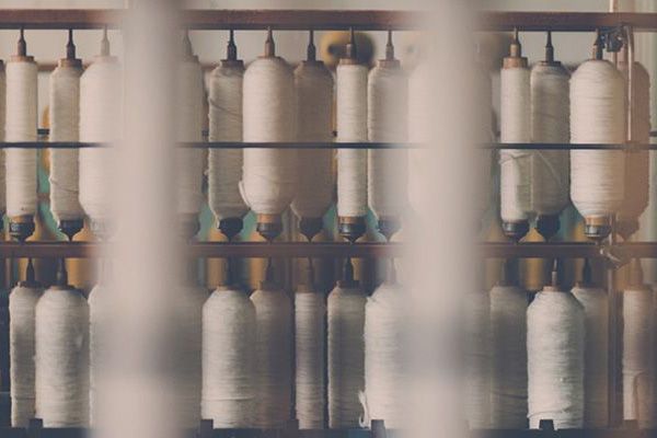 Reels of textiles in a line.