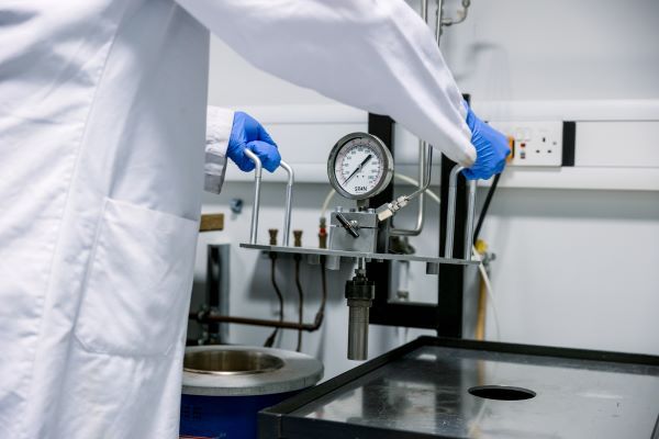 A researcher adjusts equipment in a bioenergy lab