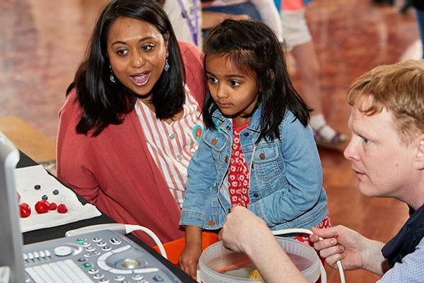 Parent and child with a staff member at Be Curious Live