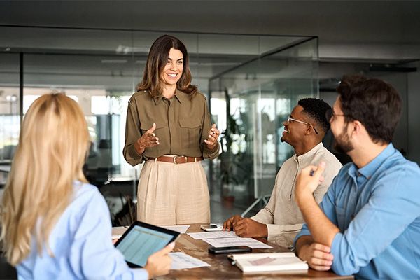 People sat around a table discussing work.