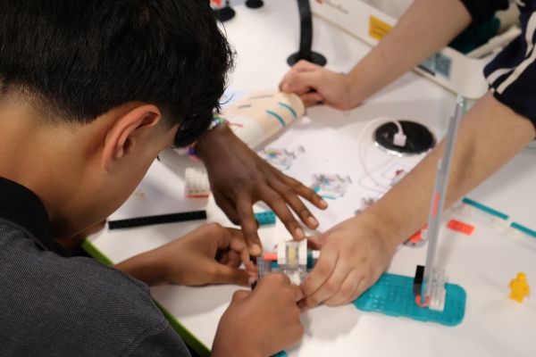 A child building a circuit board
