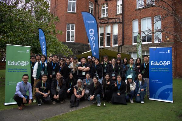 Pupils sat and stood between two EduCop banners.