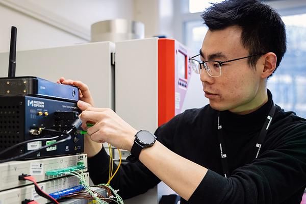 A person adjusting an electrical control system