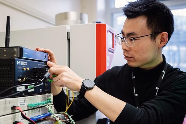 A person adjusting an electrical control system