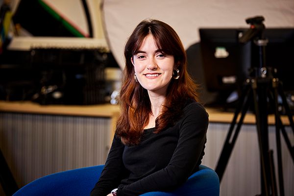 Elsa Guidon sat in a theatre smiling at the camera