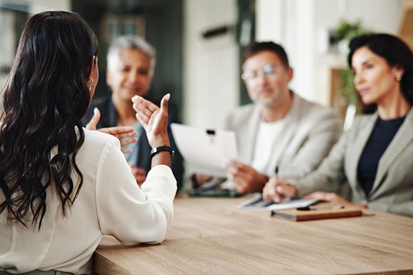 People sitting around a table having a discussion in a business setting.