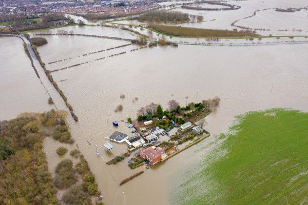 Aerial view of flooded neighbourhood, forest and field