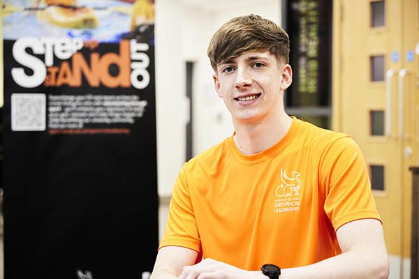 Jake smiling while seated in the Leeds University Union.