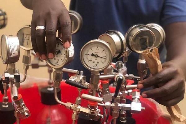 A researcher in Uganda carrying out experiments to produce biogas from water