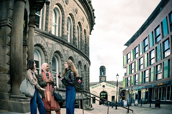 Three students stood outside the impressive circular Corn Exchange building in Leeds City Centre.